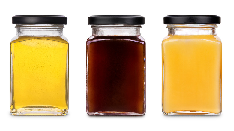 Different colors of honey in jars