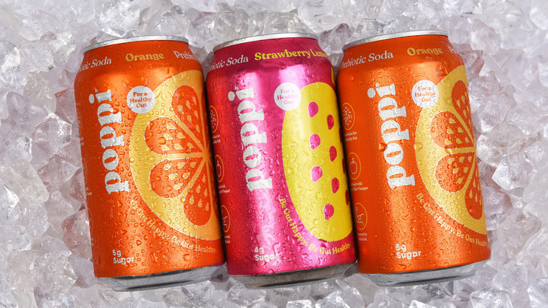 a lineup of three Poppi prebiotic sodas on ice
