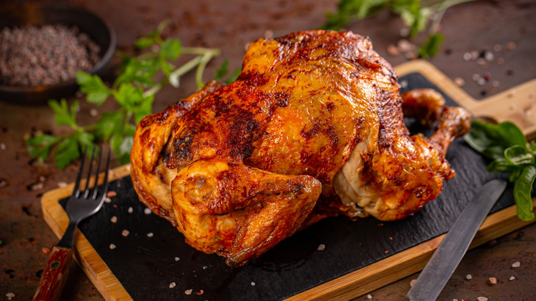 Rotisserie chicken on cutting board