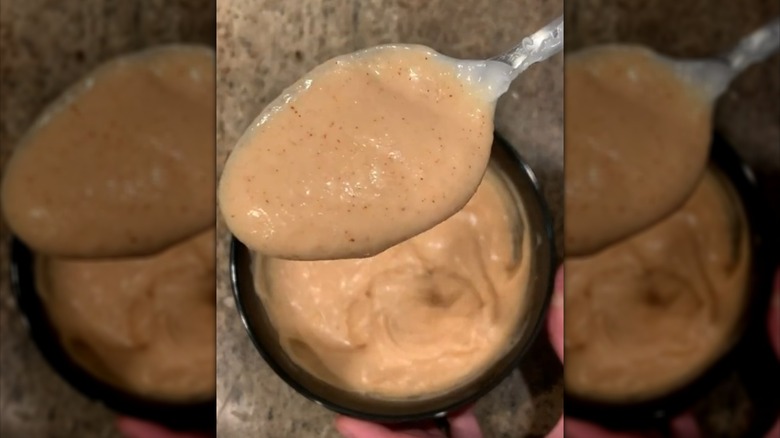 Spooning yum yum sauce from bowl