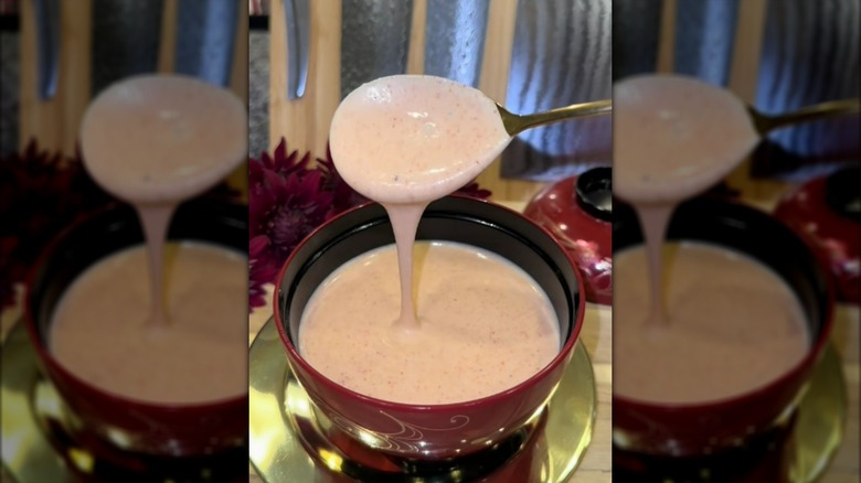 Spooning yum yum sauce from bowl