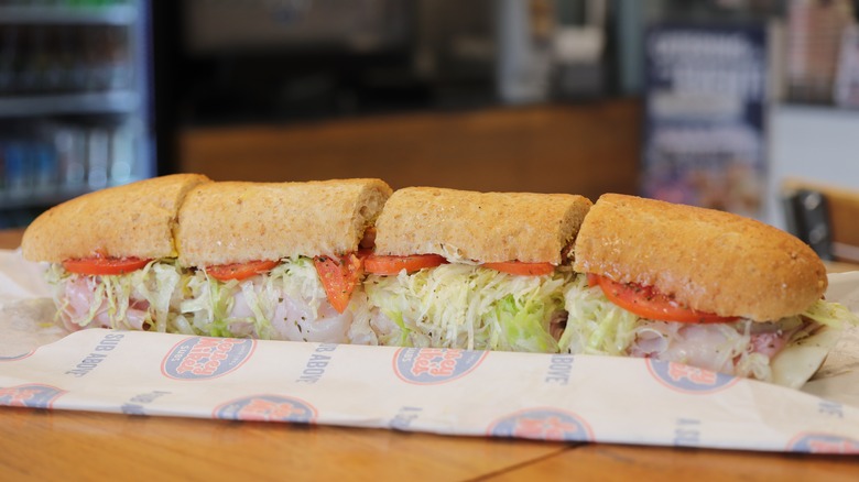 A Jersey Mike's sandwich filled with deli meat and salad