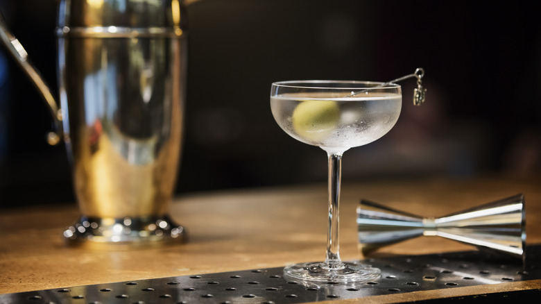 martini on bar with olive garnish