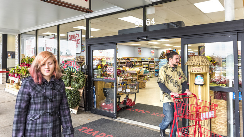 People walking at Trader Joes grocery store by entrance