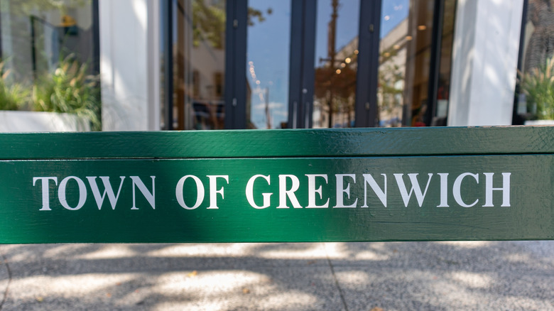 Town of Greenwich sign on a bench on a sidewwalk