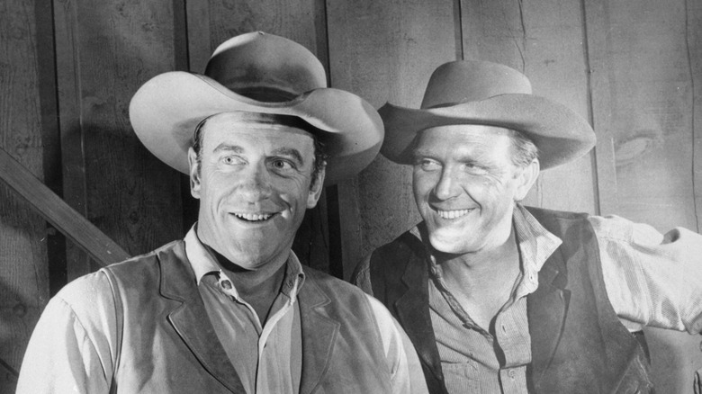 Actors James Arness on the left and Robert Lansing on the right, in costume on the set of the TV show "Gunsmoke."