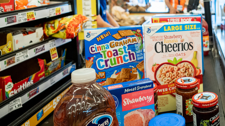 An array of groceries on a conveyer belt at the checkout stand at a Kroger grocery store
