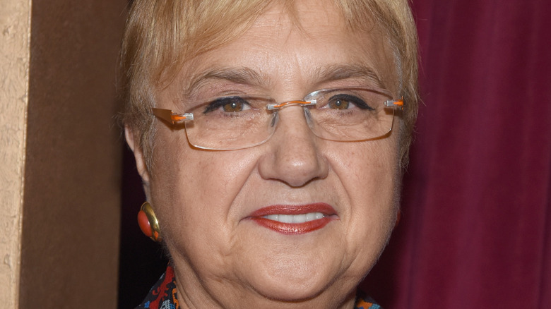 Lidia Bastianich smiles with red lipstick and glasses