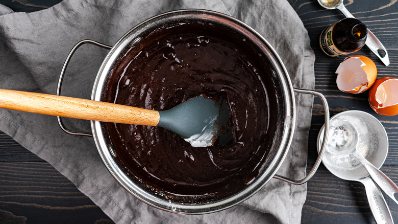 A bowl of brownie batter with a spoon in it