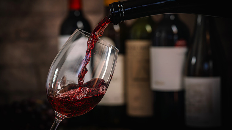 Bottle pouring Cabernet Sauvignon into a glass