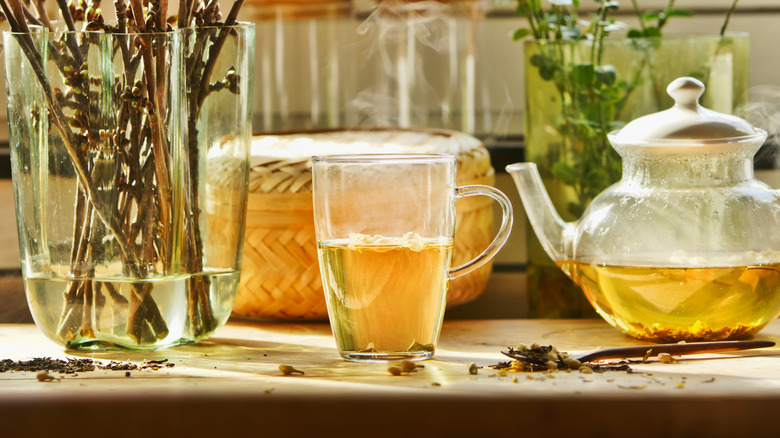 clear mug containing hot tea on kitchen counter