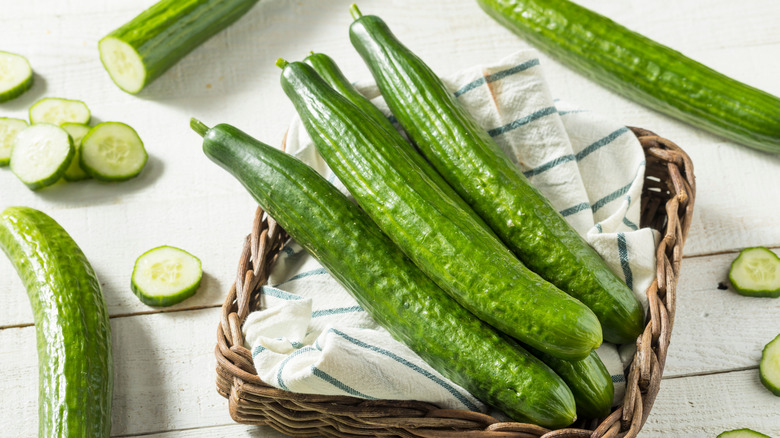 english cucumbers on kitchen towel in basket