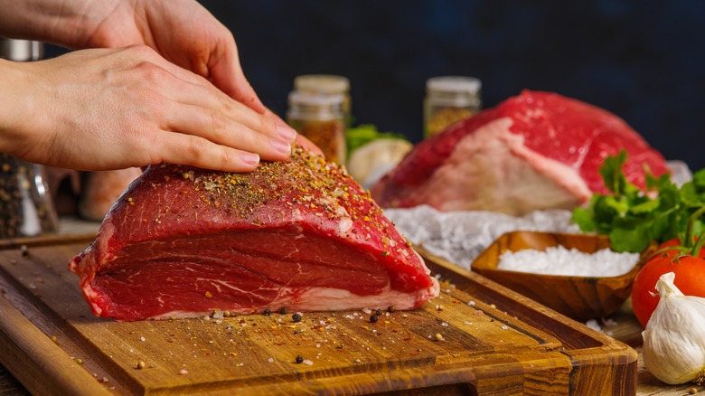 woman seasoning lean beef