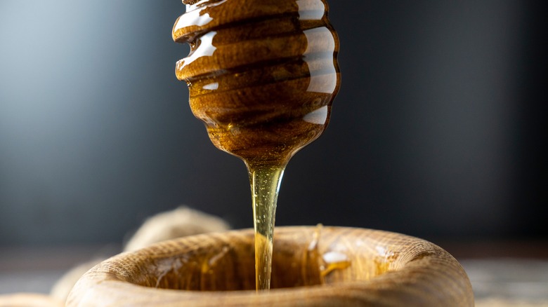 Honey drizzling into bowl