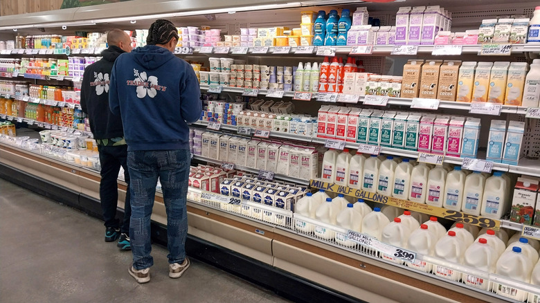 Two Trader Joe's employees inspecting a display