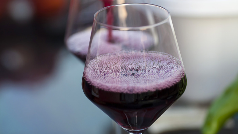 red wine pouring into glass