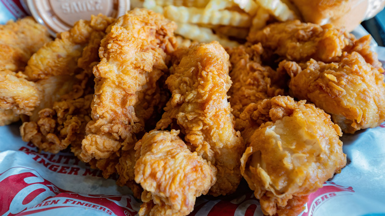 A basket of Raising Cane's chicken fingers with fries