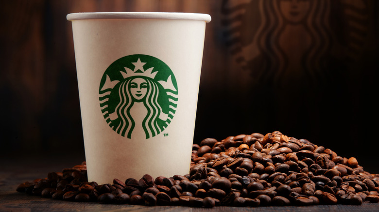 Starbucks cup with coffee beans
