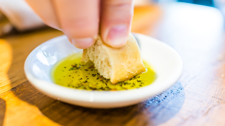 dipping bread in olive oil