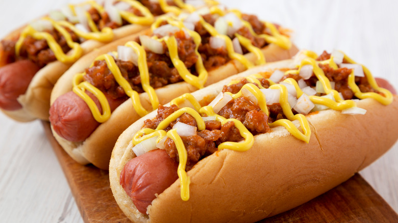 Hot dogs with chili, mustard, onion