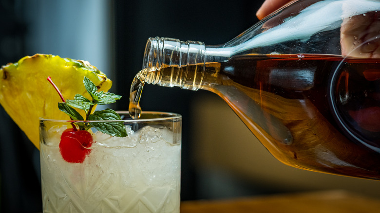 Bartender assembling a rum cocktail