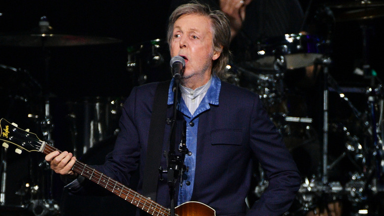 Paul McCartney performing on stage