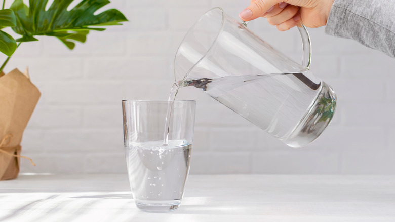 Pouring water into glass