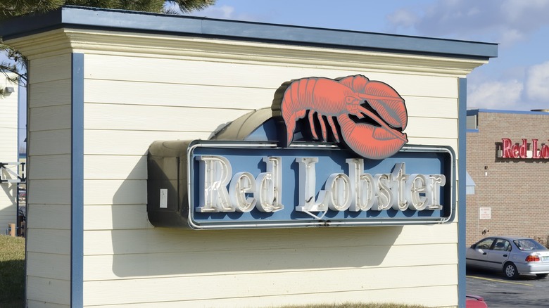 Blown-out Red Lobster restaurant sign atop dead grass