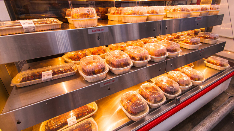 A row of rotisserie chickens in the warmer at Sam's Club.