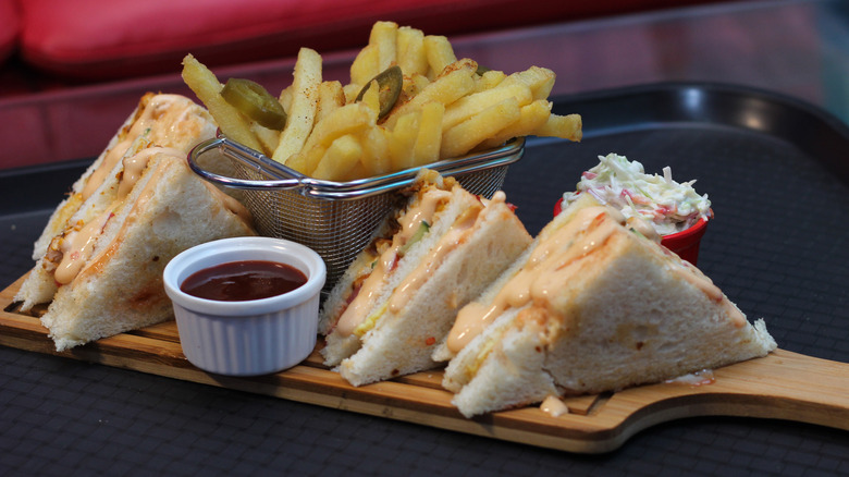 club sandwiches on tray with fries