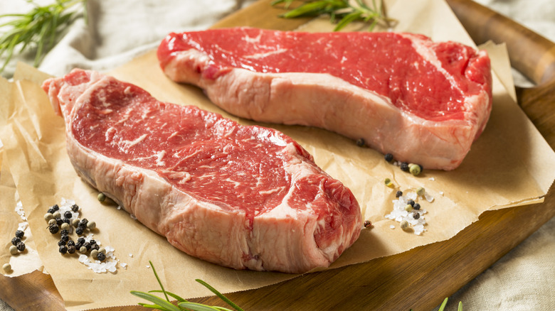 two cuts of unwrapped steak