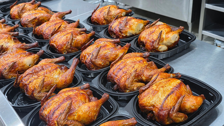 Several rotisserie chickens in containers