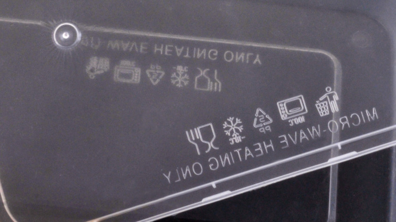 A plastic container with a variety of symbols