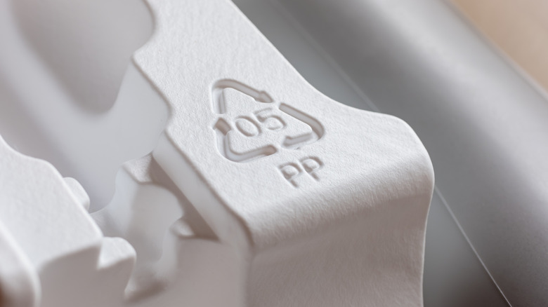 Recycling symbol #5 PP on white plastic packing insert