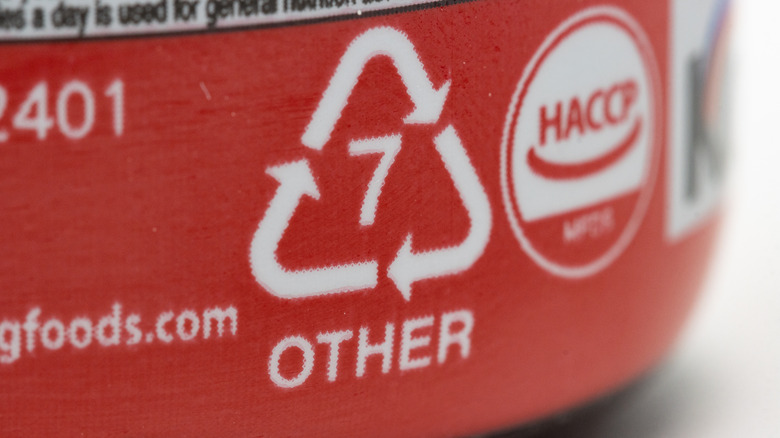 Recycling symbol #7 Other on red plastic container
