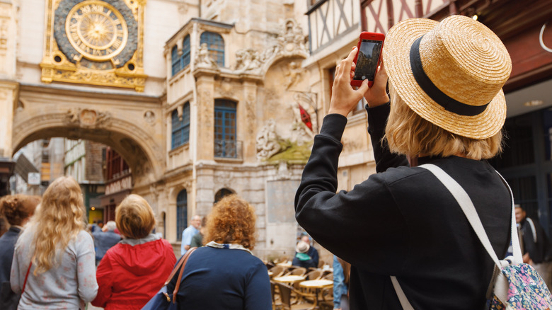 woman taking pictures while traveling