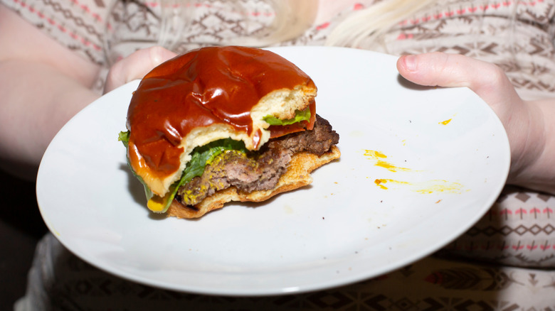 Bites taken out of a well-done burger