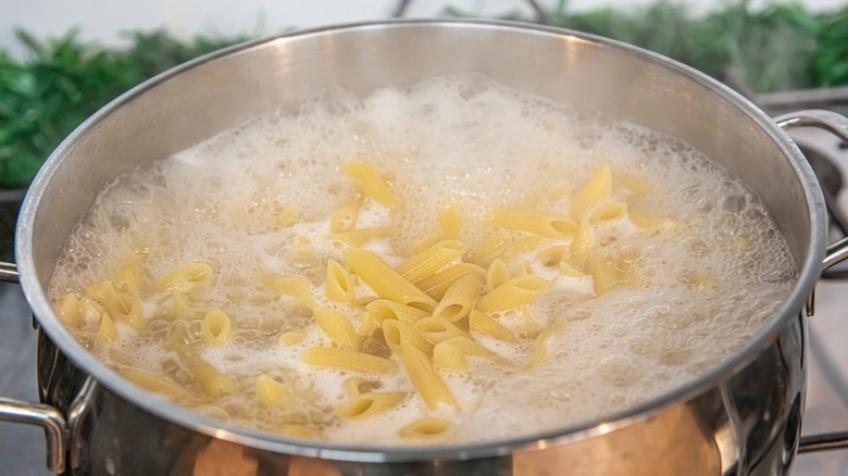 Cooking penne in boiling water