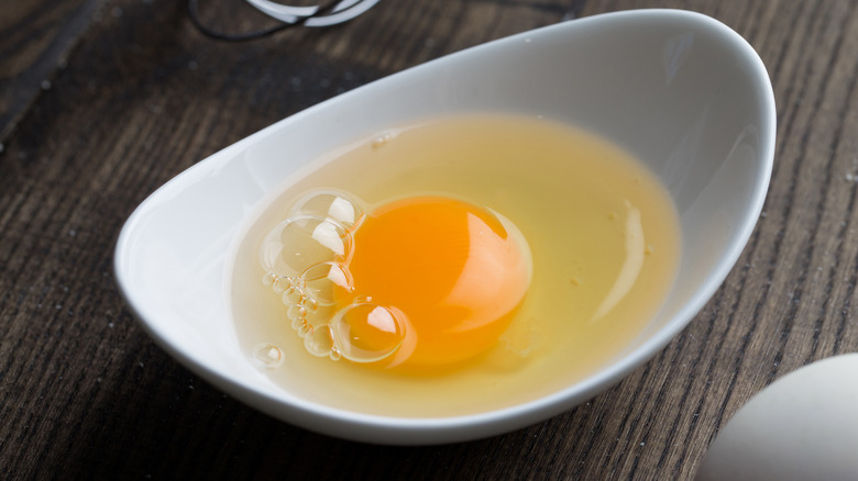 Cracked egg in dish