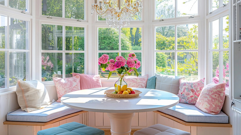 Bright and airy breakfast nook against bay windows with pastel cushions