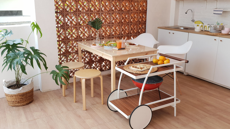 Modern breakfast nook with a kitchen trolley placed near the table