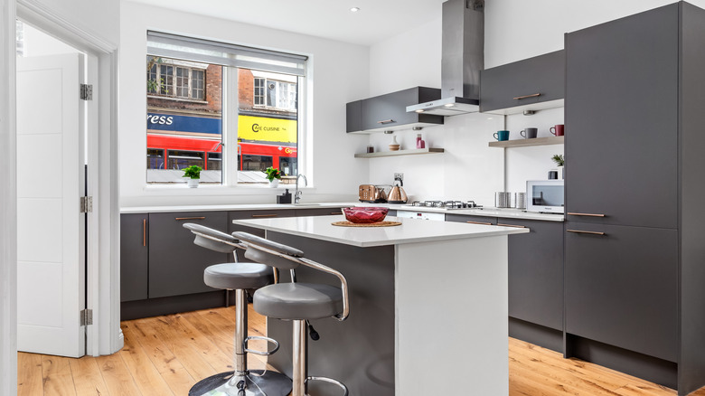 Bright apartment with a breakfast bar and two grey stools