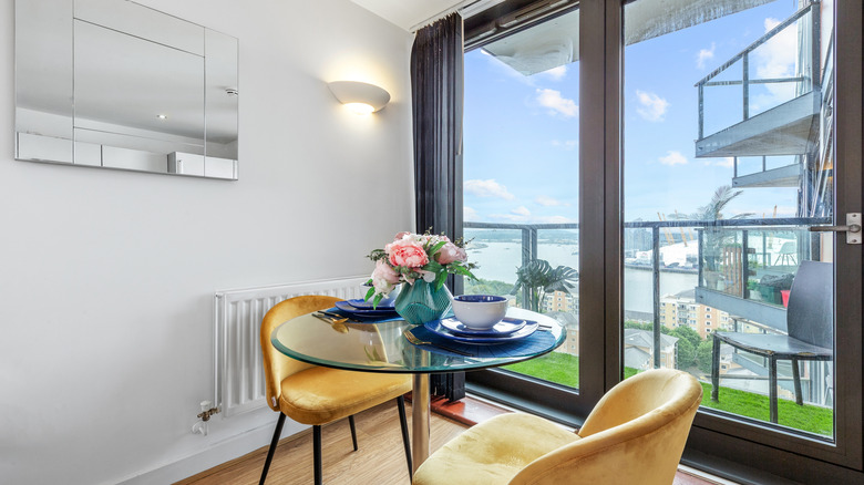 Bright breakfast nook with a floral centerpiece and blue dinnerware