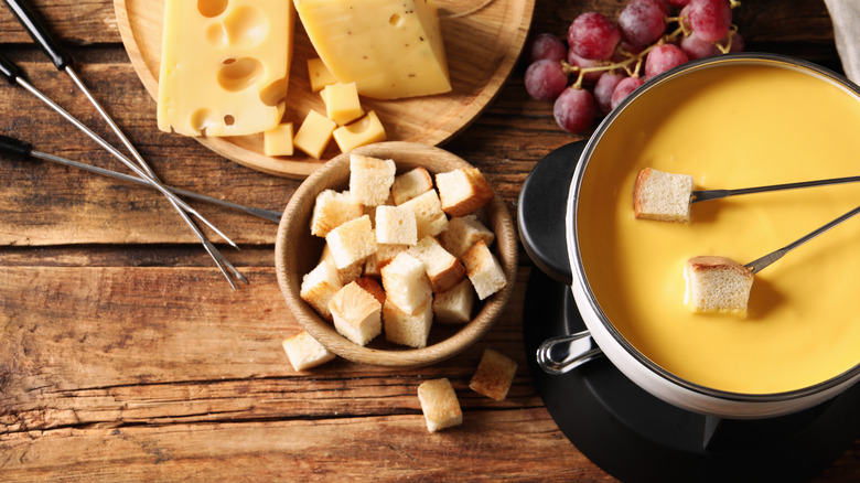 Pot of cheese fondue with forks