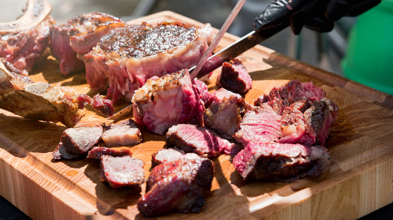 A person carving prime rib