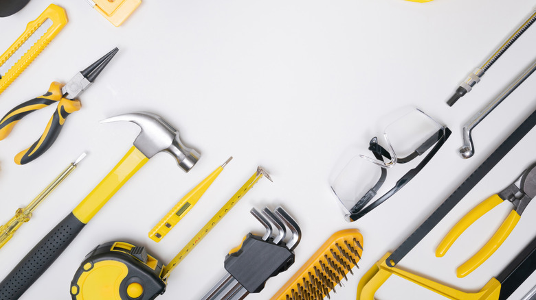 Various DIY tools including a hammer, measuring tape, and more