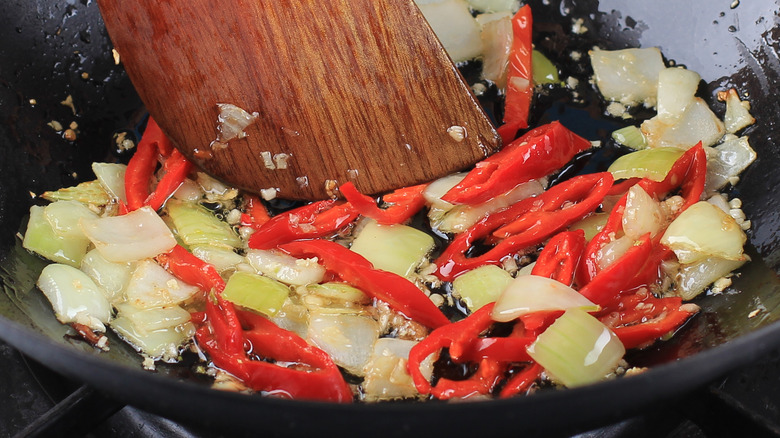 sauteing onions, garlic, and peppers in pan