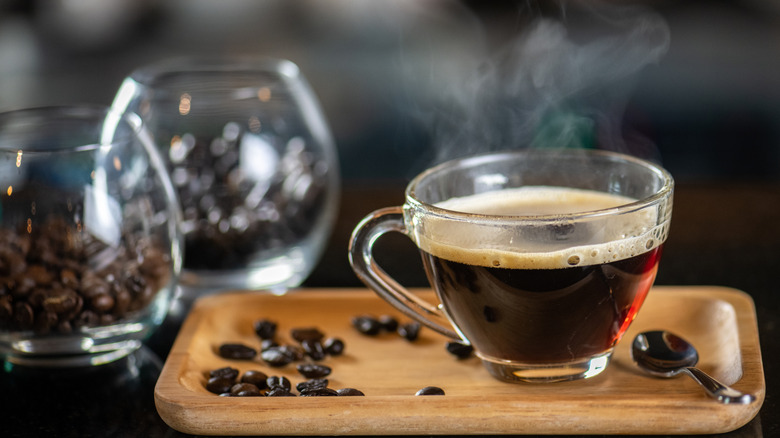 A cup of coffee on a wooden tray