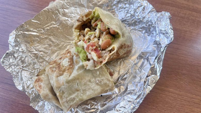 Cut chicken burrito on a table