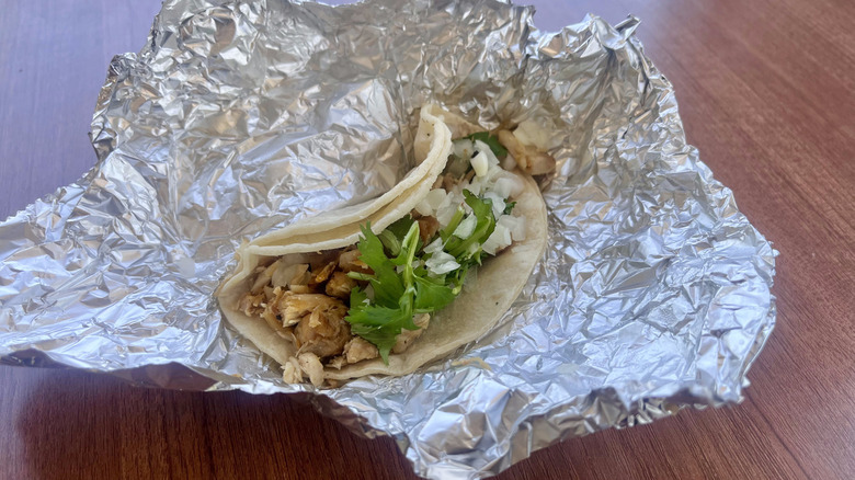 Taco in foil on a table
